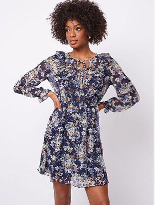 Woman wearing a navy floral 2 in 1 dress