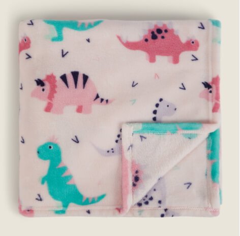 A fleece blanket with pink and teal dinosaurs.