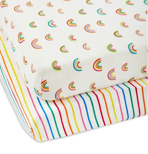 Two rainbow stripe and pattern bedsheets on mattresses.