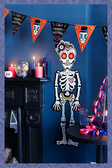 A room featuring a skeleton wall decoration and Halloween banner 