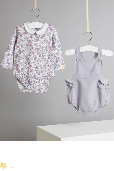 Product shot of floral bodysuit and cord dungarees on hangers 