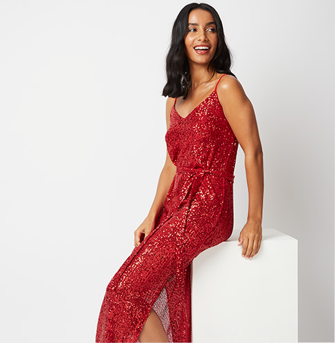 Gif of woman wearing 3 evening outfits: red sequin midaxi dress, black glitter one shoulder jumpsuit and a black sequin one shoulder frill dress 