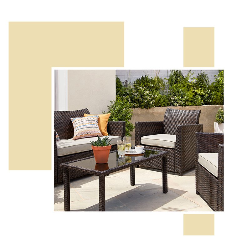 An outdoor area with a Jakarta garden furniture set with patterned cushions and accessories