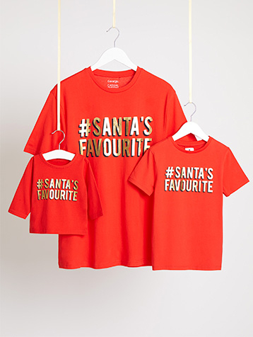Matching adult, child and baby red Mini Me T-shirts with '#Santa's Favourite' slogans on hangers hanging from string