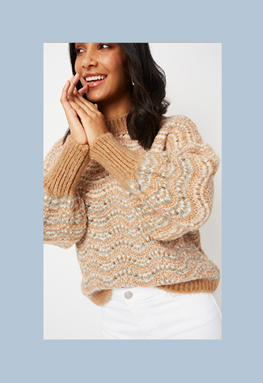 Woman in brown shimmering chunky knit jumper