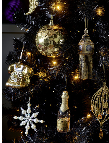 Golden baubles on a Christmas tree, including Big Ben and a telephone