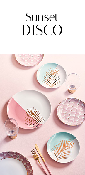 Pastel dinner plates on a pink table with gold stem glasses 