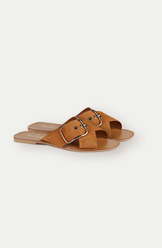 These tan suede sandals feature crossover straps and a large buckle detail