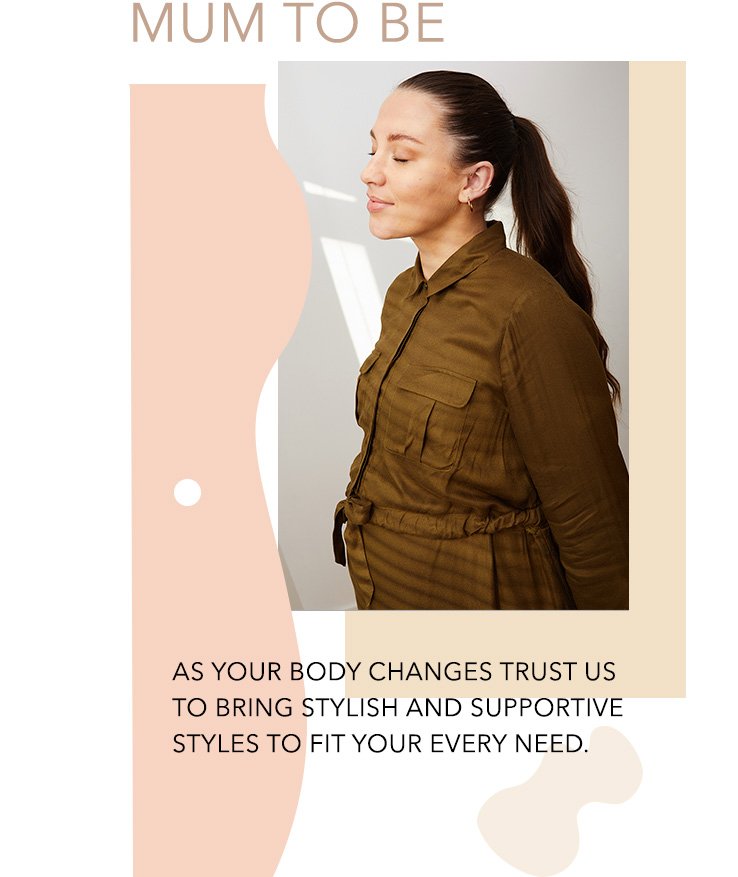 Woman with long dark hair in ponytail poses side on wearing maternity khaki belted shirt dress.