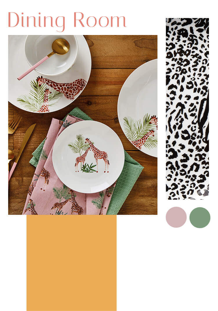 A wooden table with white crockery designed with giraffes and matching tea towels