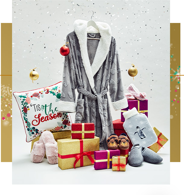 Assortment of Christmas gifts, including grey dressing gown, festive slogan cushion and a penguin hot water bottle