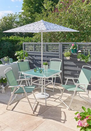 Sunny garden features miami 6 piece flower lab patio set with greenery in the background.