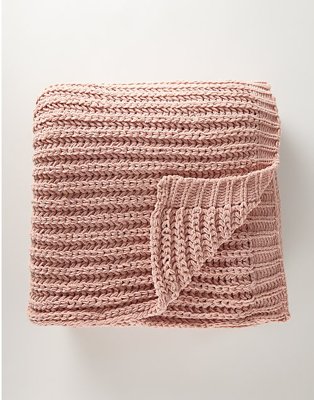 A pink knitted throw