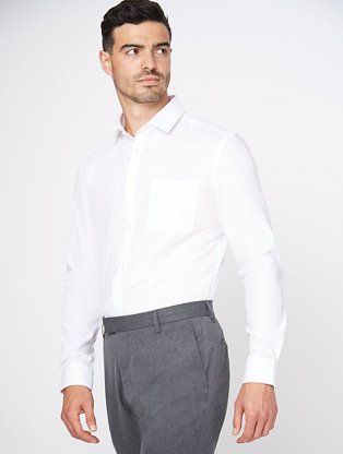 Man wearing grey formal trousers with a white long sleeved shirt