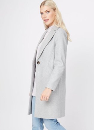 A woman wearing light wash jeans, a white top and a grey marl longline formal coat