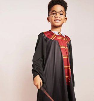 Boy poses wearing Harry Potter Fancy Dress Costume.