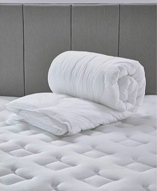 Luxury feels like down duvet rolled up on mattress topper.