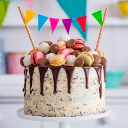 Cake covered in macaroons on a stand