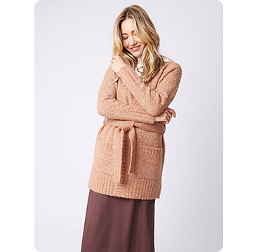 Woman wearing caramel brown longline belted bouclé cardigan and brown skirt