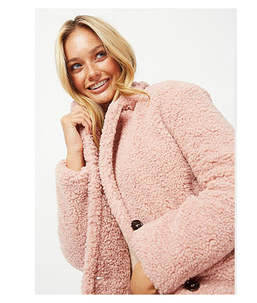 Woman wearing pink teddy coat