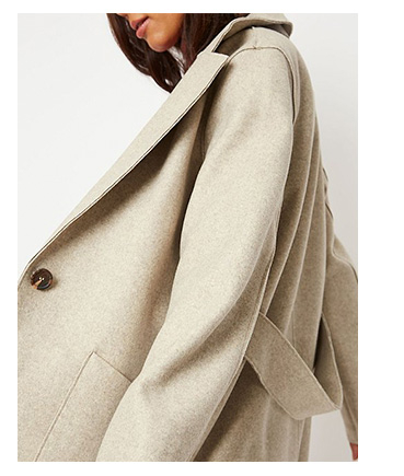 Woman wearing beige unlined longline oversized coat