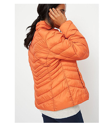 Woman wearing orange packable padded coat