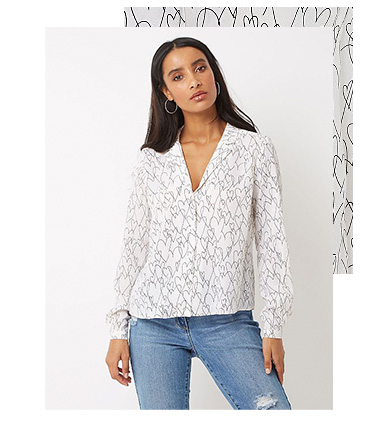 This white shirt is a must for your work-weekend wardrobe, with black heart print