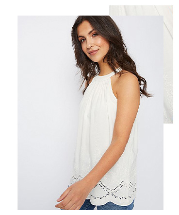 This strappy cami has a flattering high neckline and pretty cut-out detailing along the hem