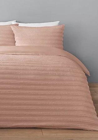Grey room features double bed with pink striped texture duvet set.