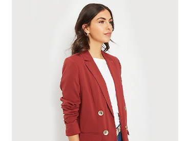 Woman wearing a white T-shirt and red button blazer