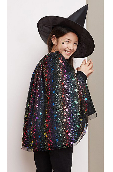 Child wearing a George Halloween shimmer star print witch hat and cape costume