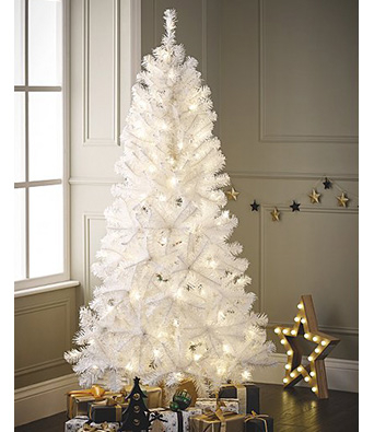 White Christmas tree by the window with presents underneath and a wooden light-up star decoration