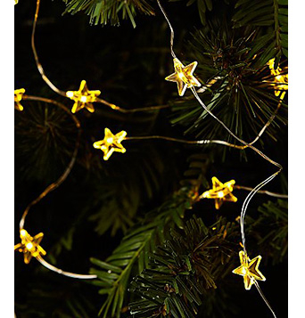 Close up of Christmas tree with yellow star-shaped lights