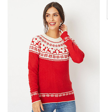 Woman wearing a red Christmas jumper and jeans