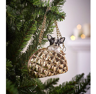 Dog in a gold handbag decoration hanging on a Christmas tree