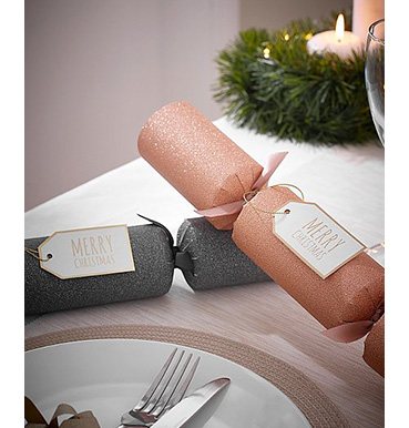 Rose gold and grey glitter Christmas crackers on a table