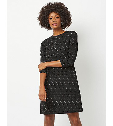 Woman in black shimmering knitted dress