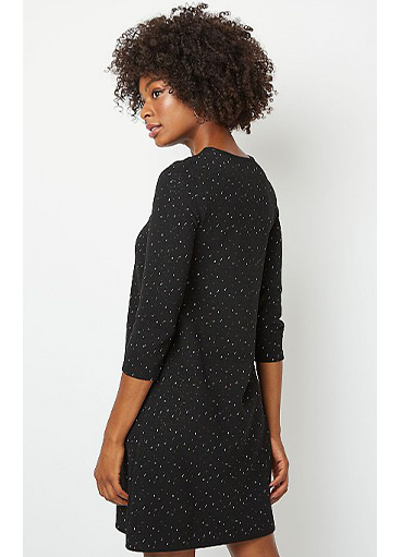 Woman wearing black shimmering knitted dress