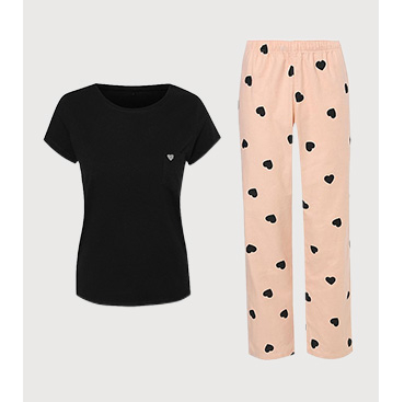 Product image of black pyjama top and pink bottoms with black hearts