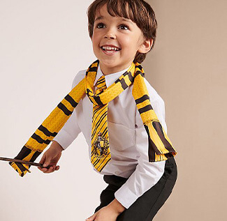 World Book Day 2020 - Boy holding a wand wearing a shirt and trousers with a Harry Potter Hufflepuff scarf and tie