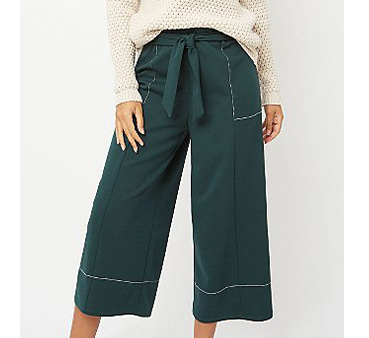 Close up shot of green wide leg trousers