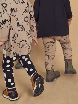 Children wearing unisex clothes and boots.