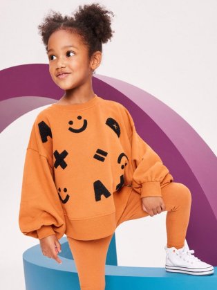 Child wearing orange loungewear suit.
