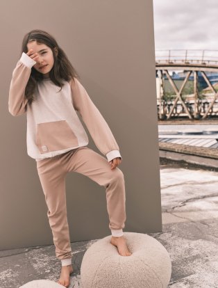 Child wearing cream and beige loungewear suit.