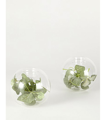Two glass balls with artificial green leaves inside