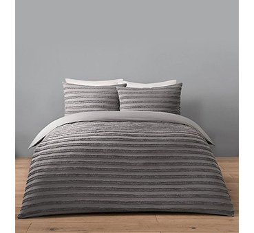 Double bed with grey striped bedding