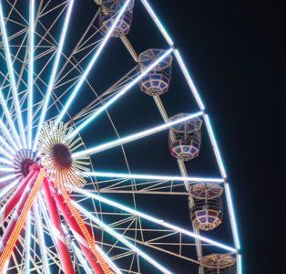 Illuminated big wheel on a dark night.