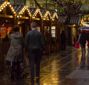 Manchester Christmas Markets at night with people walking.