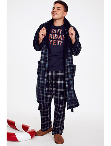 Man wearing a slogan pyjama top, check bottoms and a matching dressing gown 