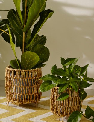 Set of 2 natural water hyacinth planters feature artificial plants.